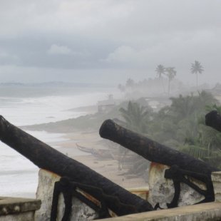 The line of cannons with Cape Coast in the background