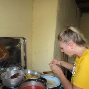 Rinsing plantains before they go into the oil