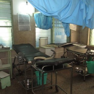 Inside the delivery room.Mothers deliver within 3 feet of each other, and the blue curtain
