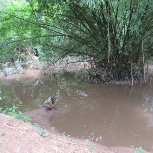 Our tour guide splashing the water where the slaves took their last bath