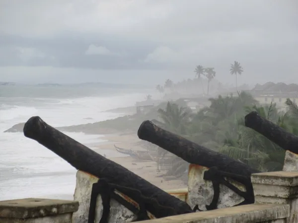 The line of cannons with Cape Coast in the background