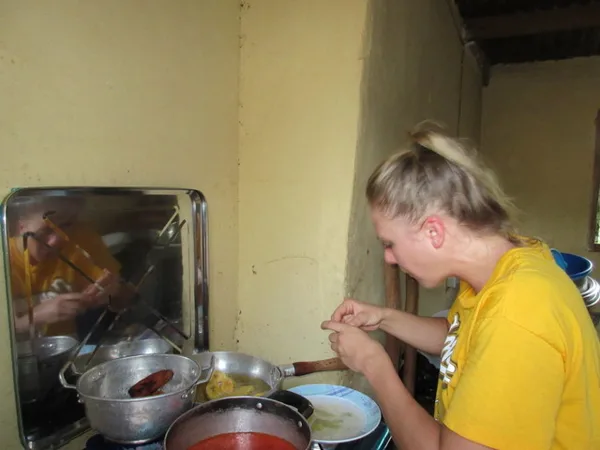 Rinsing plantains before they go into the oil