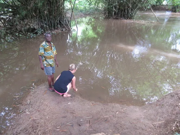 Touching the water of Slave River. Behind the bamboos tress in the right of this image is 