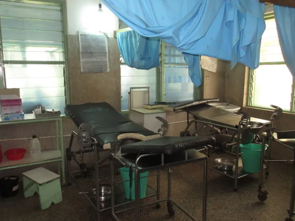 Inside the delivery room.Mothers deliver within 3 feet of each other, and the blue curtain