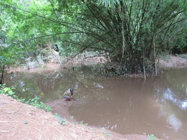 Our tour guide splashing the water where the slaves took their last bath