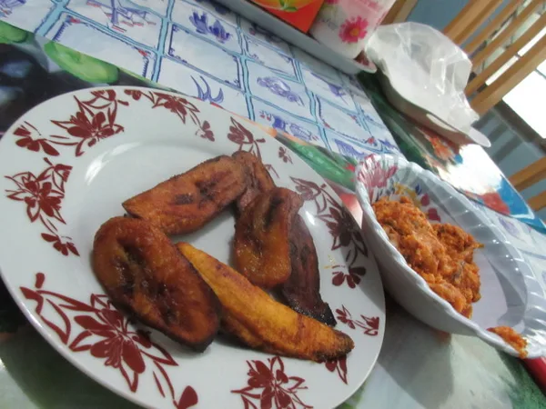 Fried plantains I heloed cook, with tomato fish stew